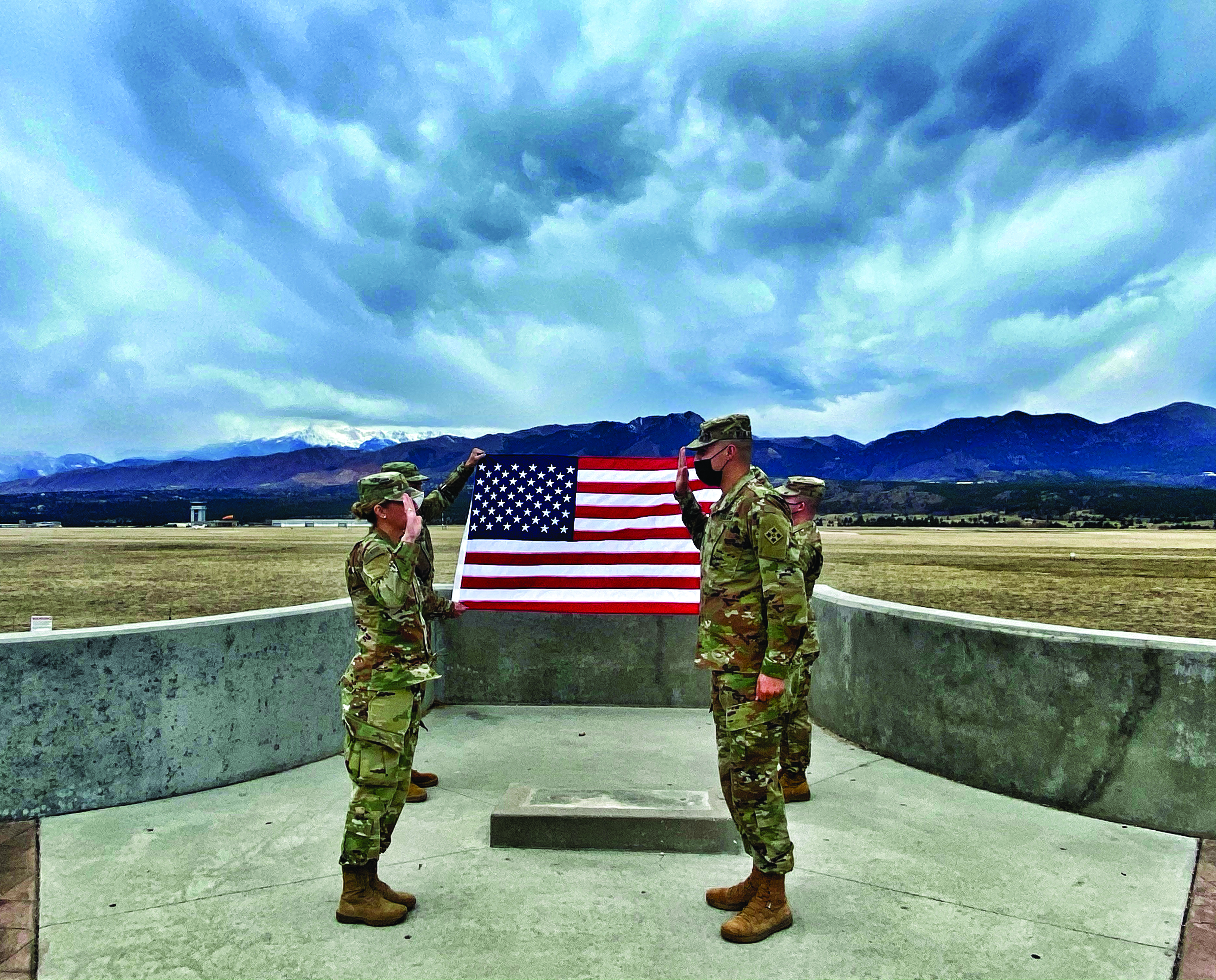 On 23 April 2021, SPC Jonathan Alvarado (right), of DIVARTY, 4th ID, re-enlisted for 4 years at the Air Force Academy Scenic Lookout. SPC Alvarado used his station-ofchoice re-enlistment option to go to Oahu, Hawaii. SPC Alvarado received the oath of enlistment from MAJ KJ Harris (left), DIVARTY, 4th ID, Brigade Judge Advocate. 